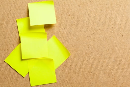 Color sticker notes over cork board background photo
