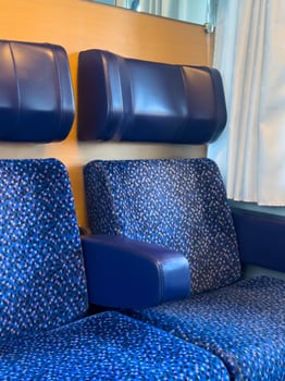 View of the blue passenger seats in the train interior photo
