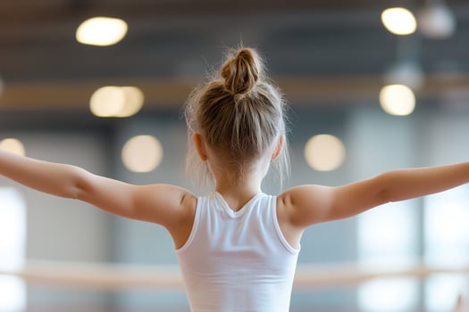 A young girl is focused on balancing on a beam, her arms extended gracefully. The softly lit gym creates an inspiring atmosphere, highlighting her determination and poise photo