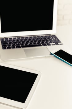 Multiple digital devices on a clean workspace, emphasizing modern technology and connectivity in everyday life photo