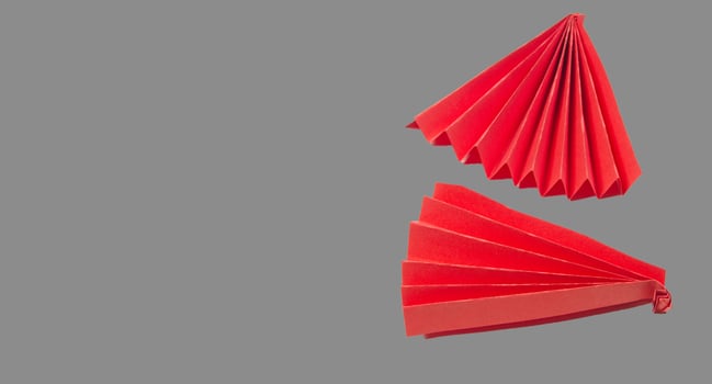 Two red origami fans are shown on a gray background photo