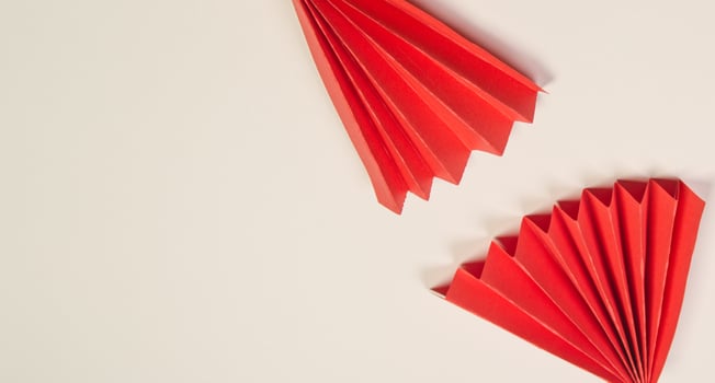 Red origami fan on white background. photo