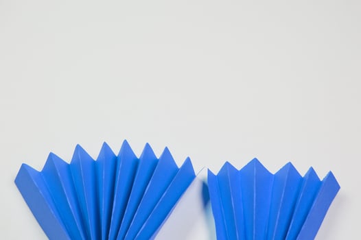 Blue origami fan on white background photo