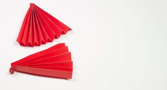 Red origami fan on white background photo