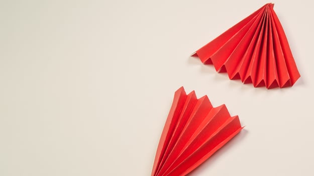Red paper origami paper cone on white background photo
