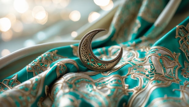 Beautifully designed crescent moon brooch on luxurious turquoise fabric with intricate gold patterns capturing elegance and charm photo