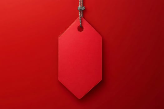 Red label hanging from string on red background photo