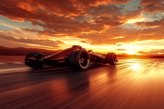 Formula one race car speeding along a track at sunset photo