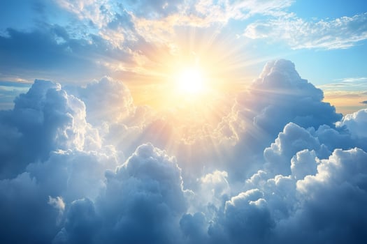 Sun shining through white clouds in blue sky photo