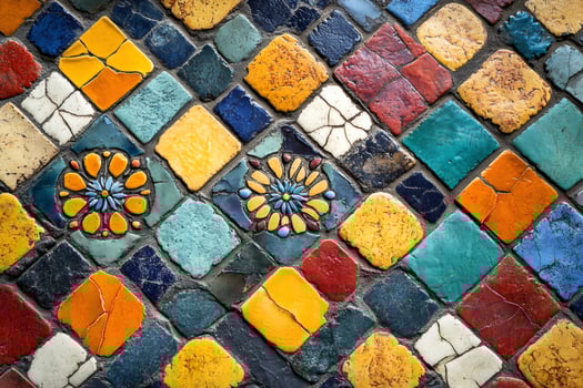 Colorful mosaic tiles forming intricate floral patterns on wall or floor photo