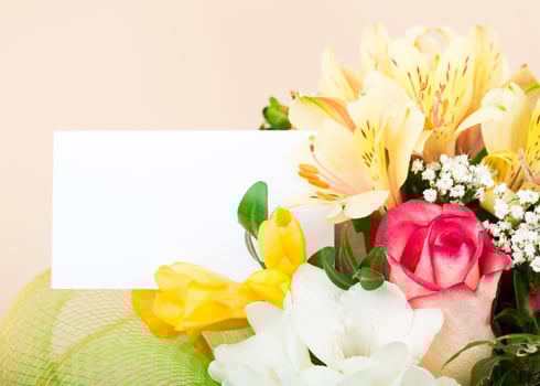 Beautiful arrangement of colorful flowers with a blank card perfect for various occasions photo
