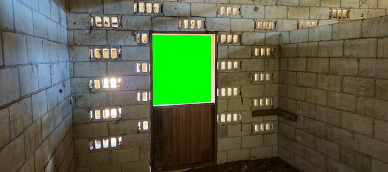 A green screen in a room with bricks photo