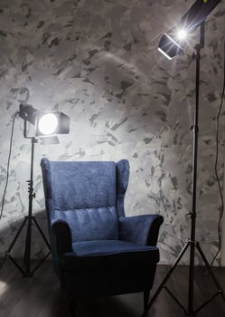 Cozy armchair illuminated by soft lighting in a modern interior setting during evening hours photo