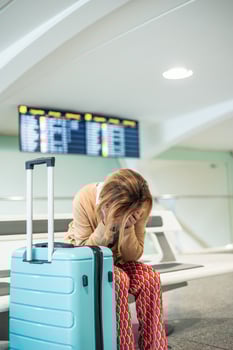 vertical Senior woman suffering from stress and anxiety waiting her delayed flight at the airport photo