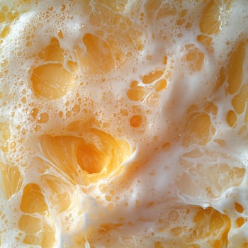 Close up of a frothy orange drink with bubbles photo