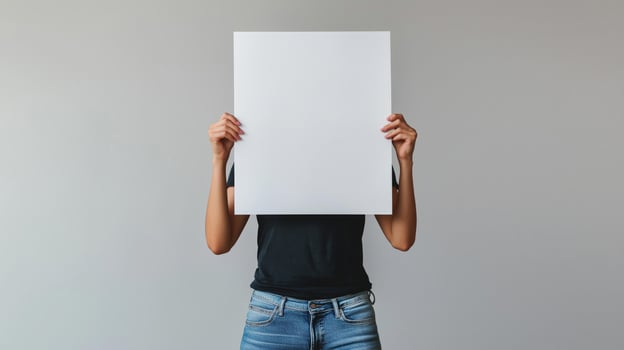 A person holding up a blank paper over their head photo