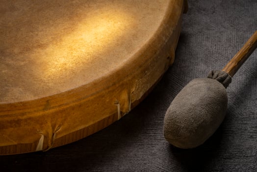 native American style, shaman frame drum covered by goat skin with a beater photo