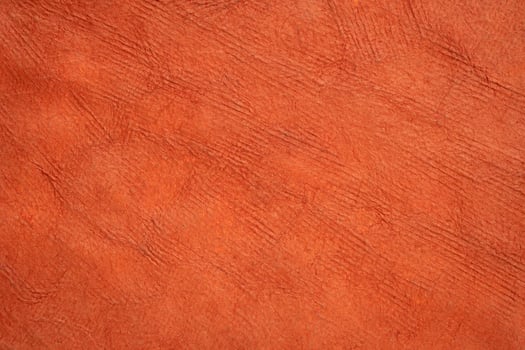macro background and texture of backlit orange bark paper handmade in Mexico photo