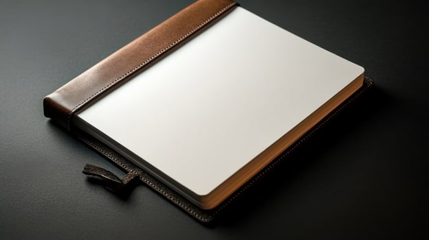 blank page in leather bound journal on dark surface invites creativity photo