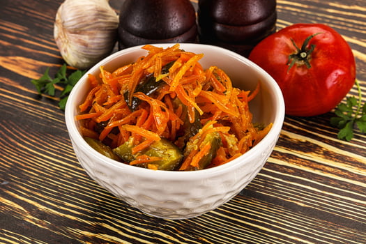 A white bowl with carrots and onions photo