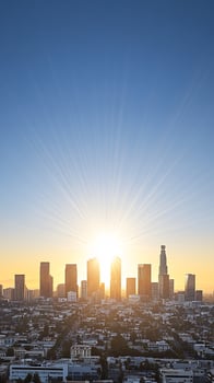 The sun rises over the city skyline in los angeles photo