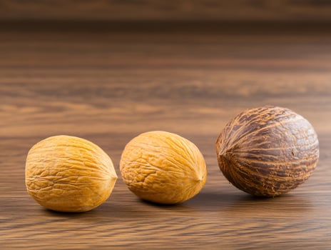 Three walnuts on a wooden table photo
