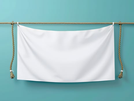 Blank white banner hanging on a rope on a blue wall photo