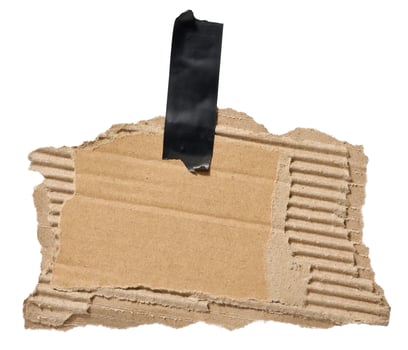 Torn piece of brown corrugated cardboard attached to a piece of electrical tape, isolated background, copy space photo