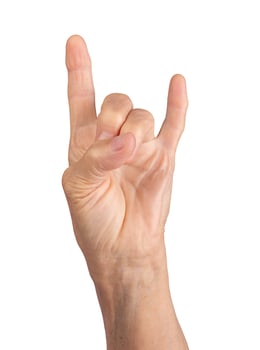 wrinkled hand showing rock music horn gesture, symbol of energy and expression, cultural sign of photo