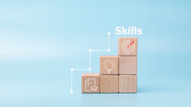 Upskilling, reskilling, new skills icon on wooden cube, Goal is constant skill growth, Improvement of personal skills in business, life and career, Upskilling and personal development concept. photo