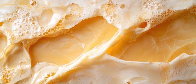 Close up of frothy golden liquid with bubbles photo