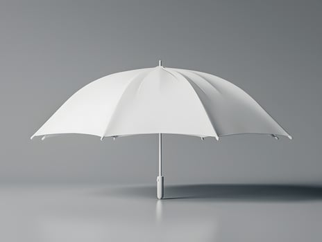 An umbrella is shown on a gray surface photo