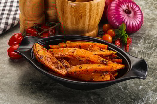 A black bowl filled with cooked vegetables and spices photo