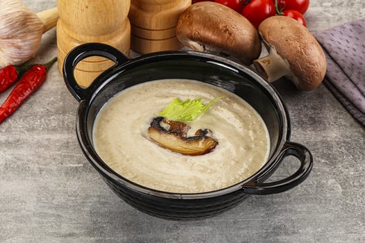 A bowl of soup with mushrooms and vegetables photo