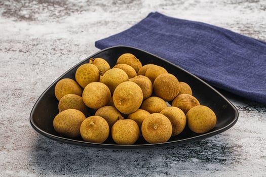 A bowl of kiwis on a table photo