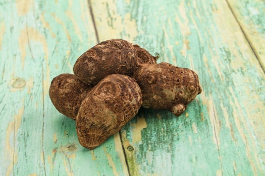A pile of brown and green roots on a wooden table photo