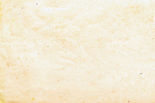 High-resolution close-up of yellowed vintage paper texture with natural fibers and a rustic, aged appearance. photo