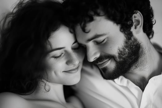 In a tender moment, a father-to-be leans his head on the belly of the mother, sharing laughter as their baby kicks softly. The blurred background enhances the feeling of intimacy photo