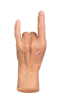 Elderly female hand making a rock horn gesture with wrinkled skin, symbolizing metal culture, photo
