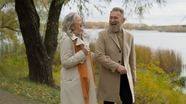 Married old happy couple in love Caucasian family mature man senior woman carefree male female walking together in park nature romantic date joyful retired husband wife enjoy walk stroll in city laugh photo