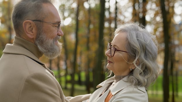 Married couple cheerful happy old age Caucasian family smiling mature senior 60s age woman man enjoying romantic outdoors tender love feelings closeness bonding adults male female talking in city park photo