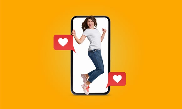 A person joyfully interacts with a smartphone featuring heart icons, symbolizing connection and affection in dating. This represents the impact of social media on relationships today. photo