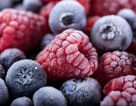 Delicate Frost on Frozen Raspberries, Blueberries, and Blackberries photo