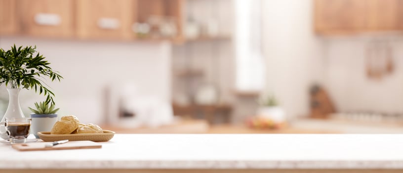 A kitchen tabletop with a blurred background of a minimalist kitchen. photo