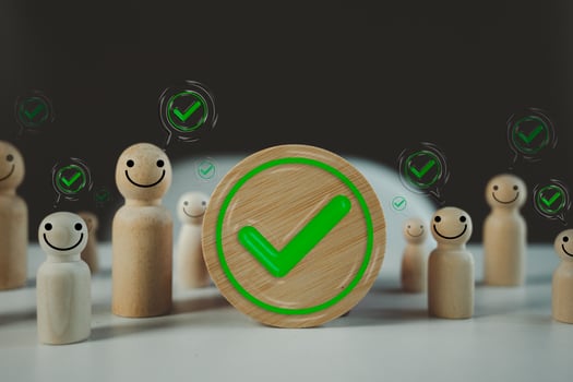 Green colored check mark in circle frame wood block with many people check mark in speech bubble photo