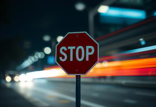 A red Stop sign in a night atmosphere, with city lights and cars on the road, blurred bokeh effect, lighting and long exposure time photo