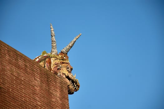 A whimsical dragon adorns a building in cimadevilla, gijon's oldest neighborhood photo