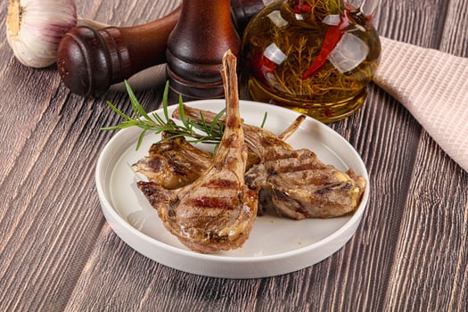 A plate of meat on a wooden table photo