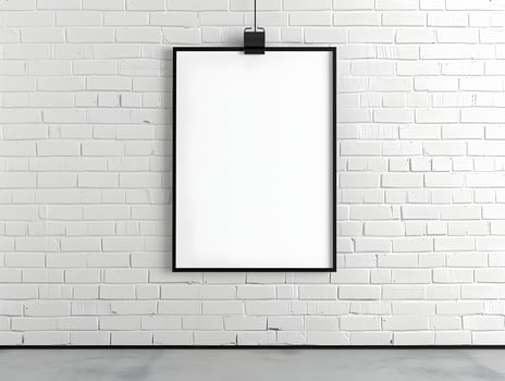 A blank white frame hanging on a brick wall photo