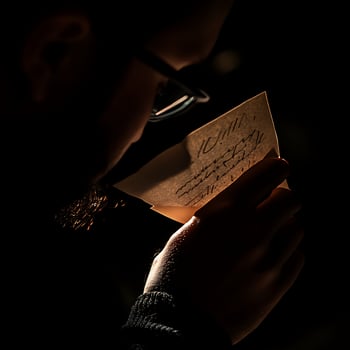 A man holding a piece of paper photo